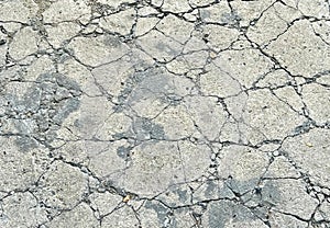a photography of a concrete surface with cracks and cracks