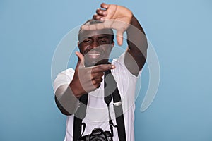 Photography enthusiast with photo device gesturing picture taking with hands photo