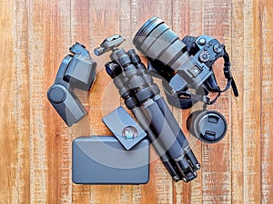 Photography Gear, Camera, tripod, flash and lenses at a wooden background