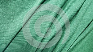 a photography of a green fabric with a very long line of lines, velvet fabric with a very thin pattern in a green color