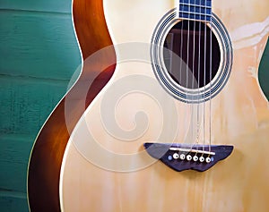 a photography of a guitar with a green background, acoustic guitar with a brown fret and a green background