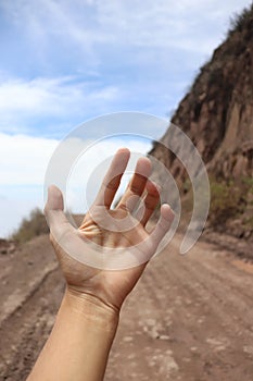 Photography of a hand on the road photo