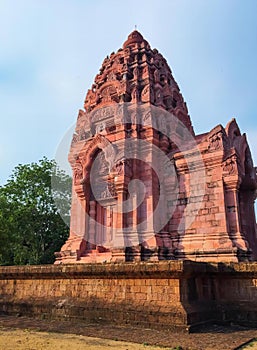 a photography of a large pink building with a clock on top, stupa bhaga temple in india with a blue sky in the background