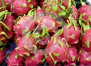 a photography of a pile of dragon fruit sitting on top of a table