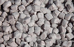 a photography of a pile of small rocks with a black background, measuring cupcake shaped rocks are shown in a close up image