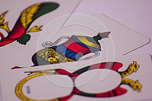 photography of playing cards with a Neapolitan design. you can see the axes of denari swords cups and sticks.