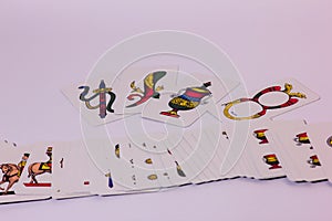 photography of playing cards with a Neapolitan design. you can see the axes of denari swords cups and sticks.