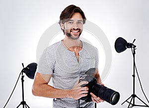 Photography, portrait and happy with camera in studio for career, behind the scenes and backpack. Photographer, person