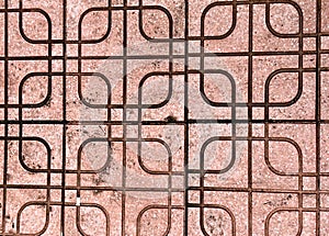 a photography of a red brick wall with a metal grate pattern, padlocked metal grate with a pattern of squares and rectangles