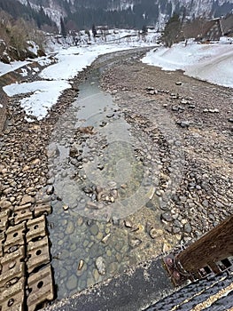 a photography of a river running through a rocky valley, lumbermill creek in the mountains with a stream running through it