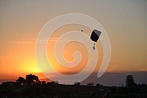 Photography of shadows skydivers in sunset