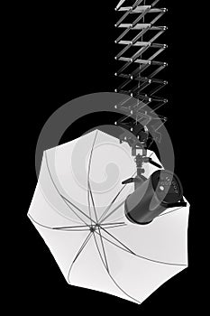 Photography studio flash on ceiling pantograph with umbrella isolated on black