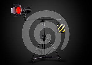 Photography studio flash on a lighting stand isolated on black background