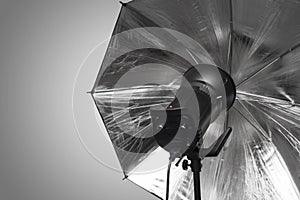 Photography studio strobe flash with silver umbrella