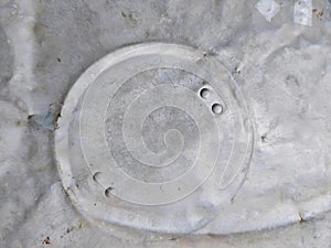 a photography of a toilet seat with holes in it, nematode worm hole in concrete with holes in it