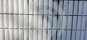 a photography of a white bamboo fence with a black stripe, white bamboo poles are stacked in a row