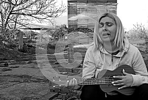 Photography of woman playing ukulele photo