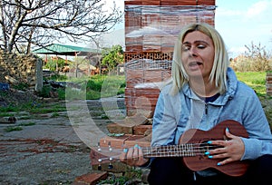 Photography of woman playing ukulele photo