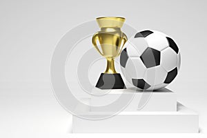 Soccer ball and a gold cup in a white studio