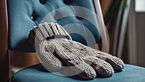 Photorealistic image of a knitted glove left on chair