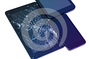 Photos of cracked display on a tablet and black cellphone isolated on white. Tablet with damaged screen.