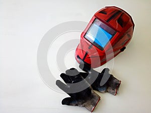 Photos of dirty welding gloves, welder& x27;s mask in the workshop.Space for your text.