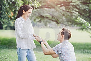 Photos of engagements, marriage proposals, and newly engaged couples lover young man and lady outdoor green park