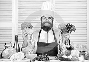 Photos of food. Vegetarian. Mature chef with beard. Bearded man cook in kitchen, culinary. Chef man in hat. Secret taste