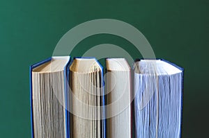 Photos of several books on a khaki background