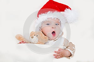 Photos of smiling young baby in a Santa Claus hat