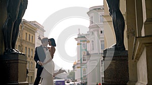 Photosession of a beautiful elegant wedding couple inside the porch of the New Hermitage by the feet of atlantes. Action
