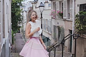 photoshoot in Paris in Montmartre, portrait of young smiling woman model, France