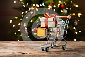 PhotoStock Mini shopping cart with gift box, festive shopping concept