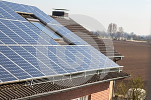 Photovoltaic panels on a roof as sun collectors and solar panel on roof deliver green energy with zero emissions for sustainable