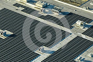 Photovoltaic solar panels mounted on industrial building roof for producing green ecological electricity. Production of