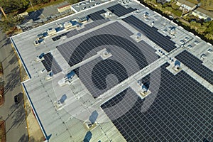 Photovoltaic solar panels mounted on industrial building roof for producing green ecological electricity. Production of