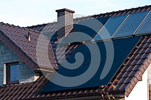 Photovoltaic solar panels on the roof of a modern house