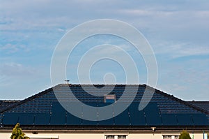 Photovoltaic solar panels on the roof of a modern house