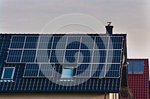 Photovoltaic solar panels on the roof of a modern house