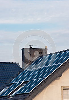 Photovoltaic solar panels on the roof of a modern house