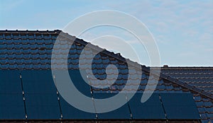 Photovoltaic solar panels on the roof of a modern house