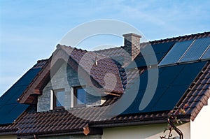 Photovoltaic solar panels on the roof of a modern house