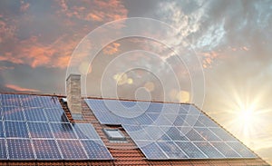 Photovoltaic or solar panels on roof at sunset