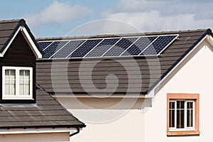 Photovoltaic Solar Panels on tiled roof photo