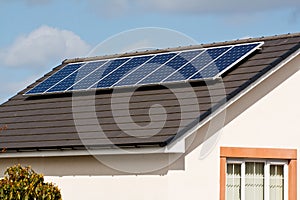 Photovoltaic Solar Panels on tiled roof photo