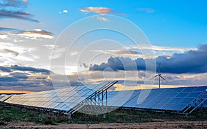 Photovoltaic and wind plant at sunset