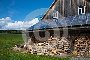 Photovoltaik panels and fire wood photo