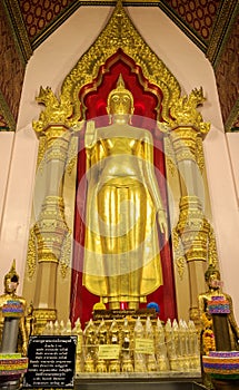 Phra Ruang Rodjanarith standing Buddha in the tallest and biggest stupa, pagoda in the world. photo