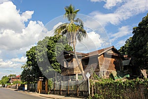 Vintage timbered wooden architecture of a house in a green neighbourhood in the Thai town of