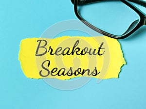 Phrase Breakout Seasons written on yellow torn paper with eye glasses.
